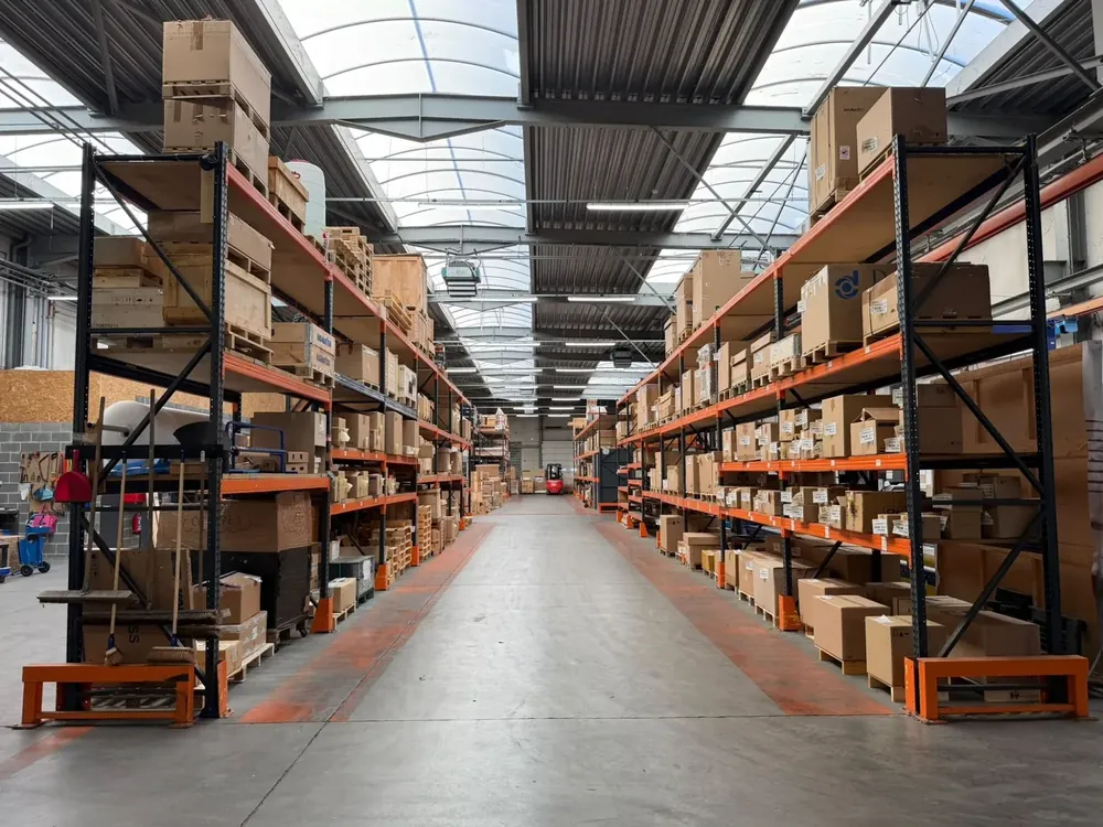 Aisle of the TMS bonded warehouse in Alleur, with shelves of parts ready to ship